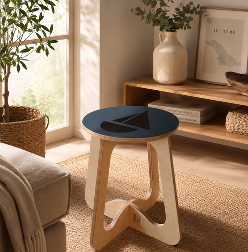 Tabouret, chevet ou guéridon avec piétement Ré-tro et assise voilier noir sur fond bleu. Tabouret réalisé entièrement dans l'atelier ey Ben !, atelier d'ébénisterie sur Loix